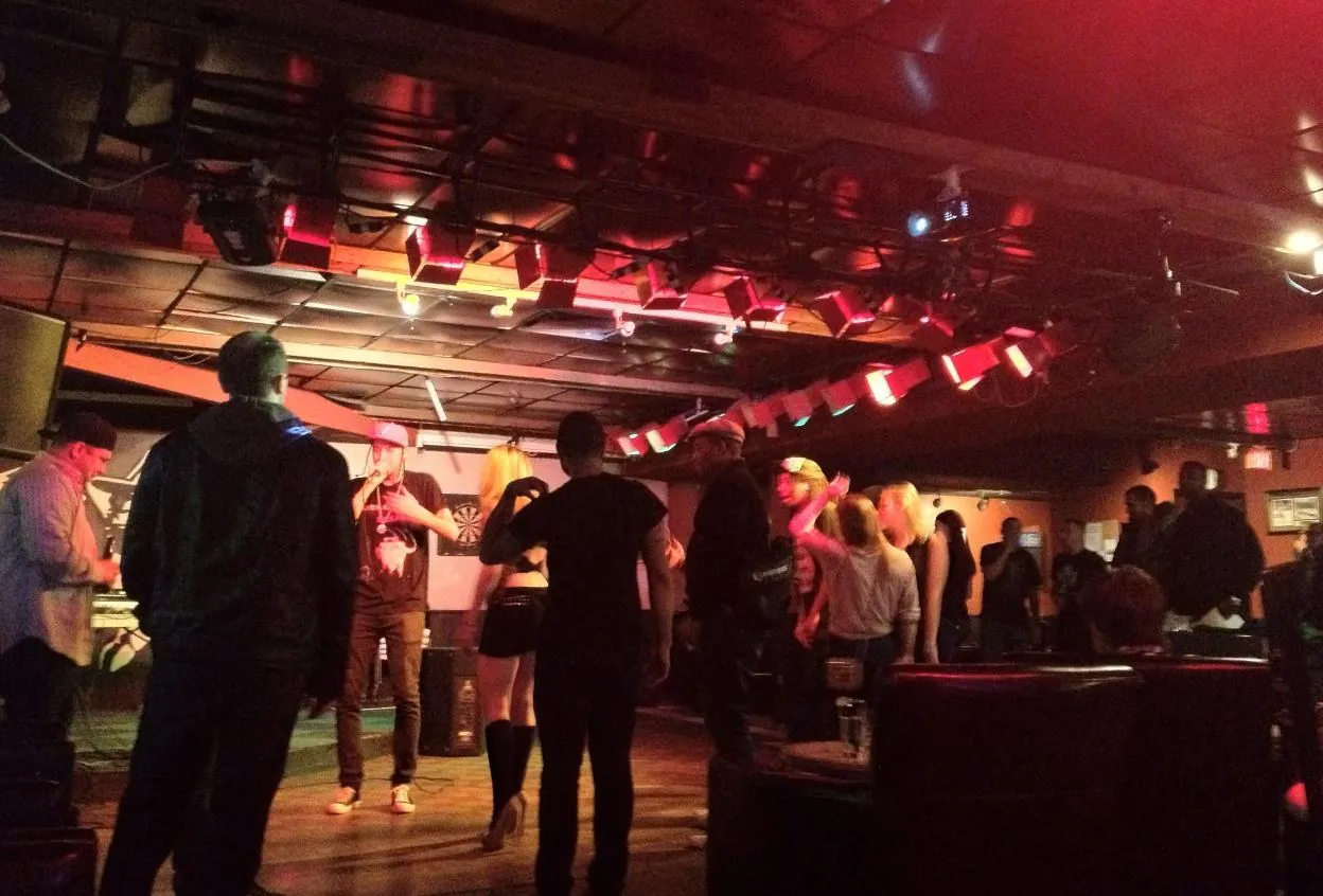 The main floor of Less Than Level bathed in red light